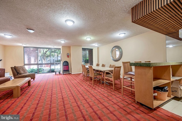 interior space with floor to ceiling windows and a textured ceiling