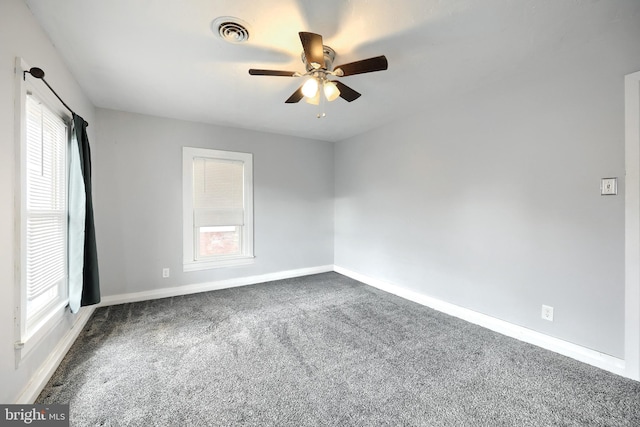 carpeted spare room with ceiling fan