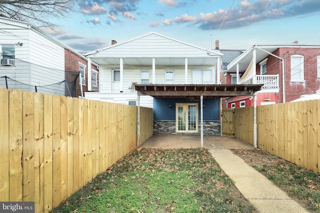 rear view of house with a patio area and french doors