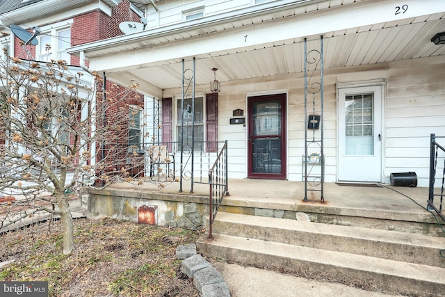 view of exterior entry featuring a porch