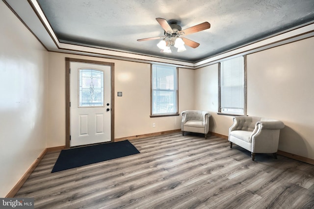 unfurnished room with crown molding, ceiling fan, and wood-type flooring