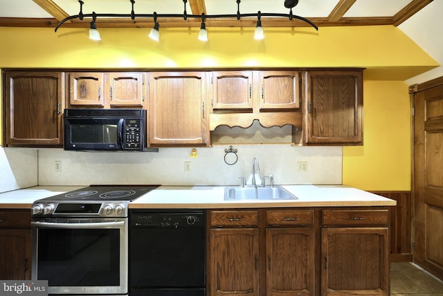 kitchen featuring sink, dark tile patterned floors, backsplash, wood walls, and black appliances