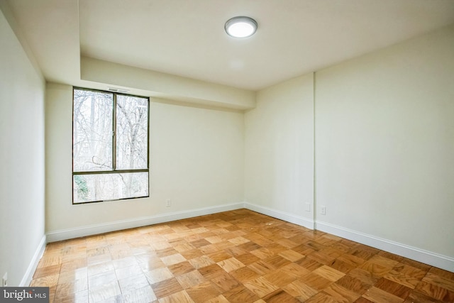 unfurnished room with light parquet flooring