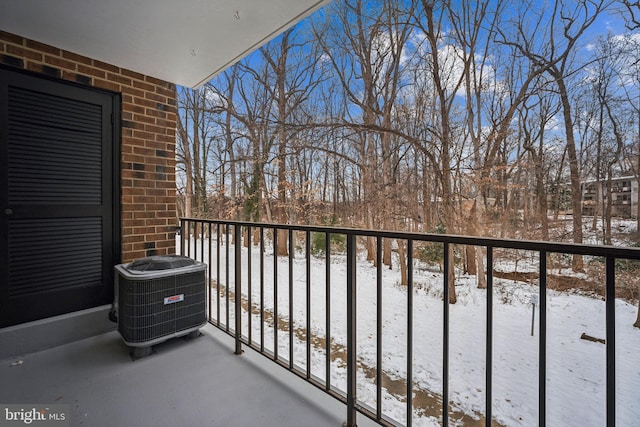 snow covered back of property with cooling unit