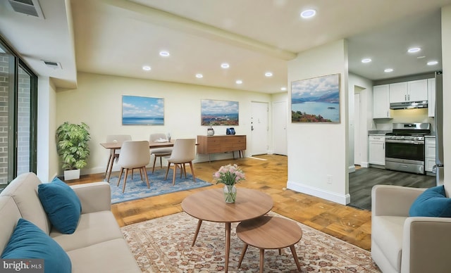 living room with parquet flooring and beam ceiling