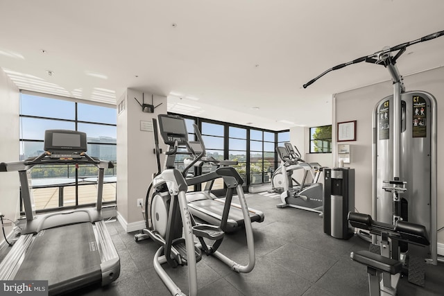 exercise room with a water view and a wall of windows