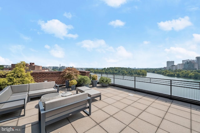 view of patio / terrace featuring outdoor lounge area and a water view