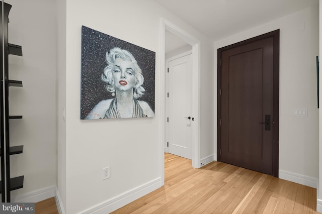 hallway with light hardwood / wood-style flooring