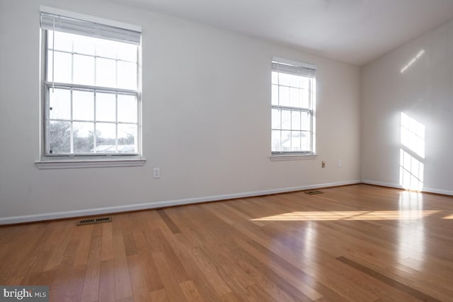 empty room with light hardwood / wood-style floors