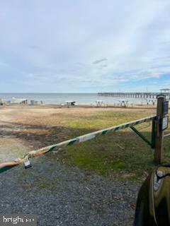 view of yard featuring a water view and a view of the beach