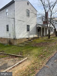 view of property exterior featuring a lawn