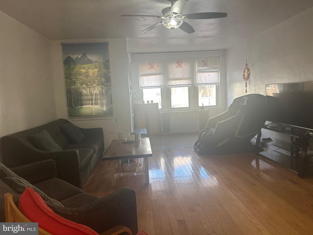 living room featuring ceiling fan and hardwood / wood-style floors