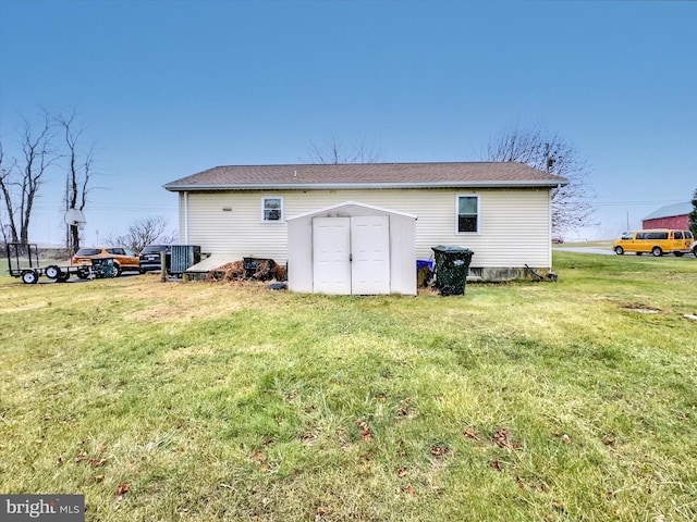 rear view of house featuring a storage shed and a lawn