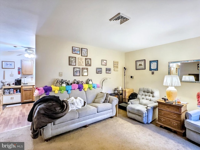 living room with ceiling fan and light carpet