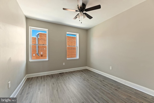 empty room featuring hardwood / wood-style flooring and ceiling fan