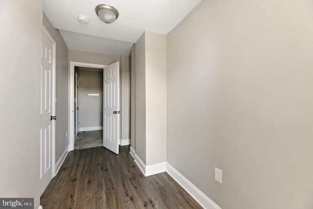 corridor featuring dark hardwood / wood-style flooring