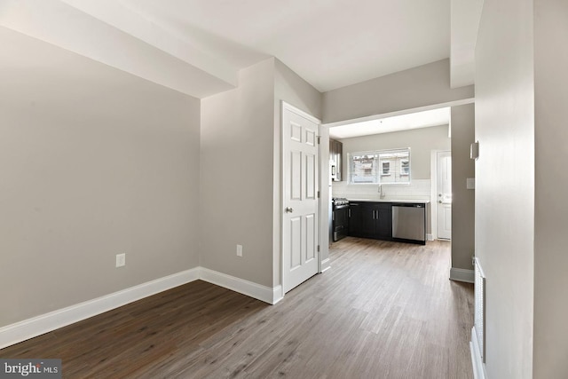 hall with hardwood / wood-style floors and sink