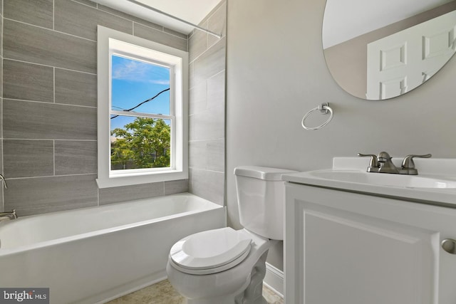 full bathroom featuring vanity, tiled shower / bath combo, toilet, and plenty of natural light