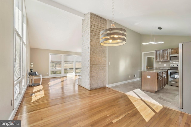 kitchen featuring light hardwood / wood-style floors, hanging light fixtures, appliances with stainless steel finishes, and a chandelier