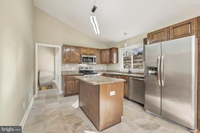 kitchen with light stone countertops, a center island, sink, high vaulted ceiling, and appliances with stainless steel finishes