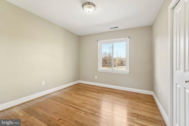 unfurnished room with light wood-type flooring