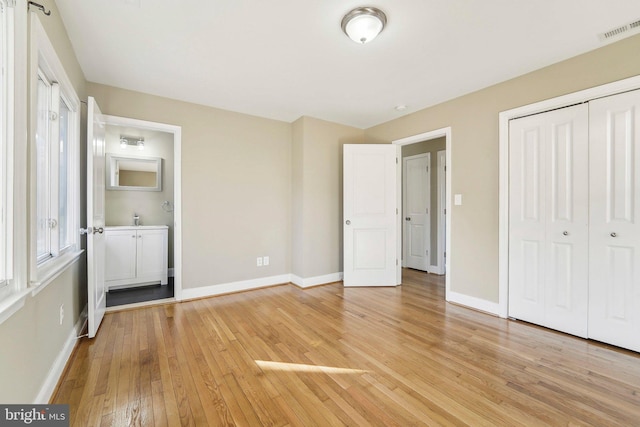 unfurnished bedroom with a closet and light hardwood / wood-style flooring