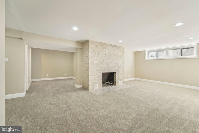 basement with carpet flooring and a brick fireplace