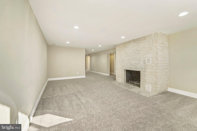 unfurnished living room featuring carpet flooring and a brick fireplace