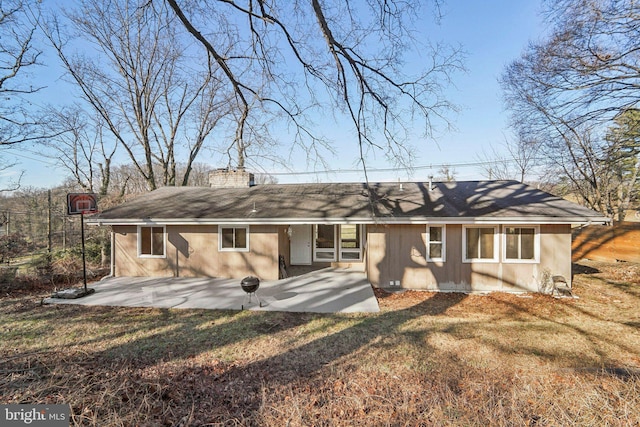 back of property featuring a yard and a patio