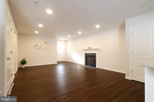 unfurnished living room featuring dark wood-type flooring