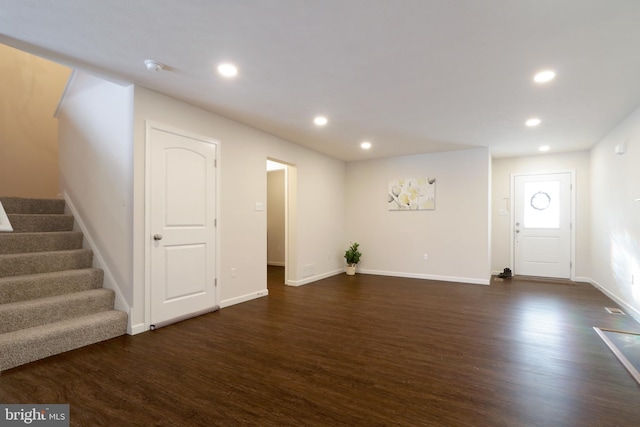 unfurnished living room featuring dark hardwood / wood-style flooring