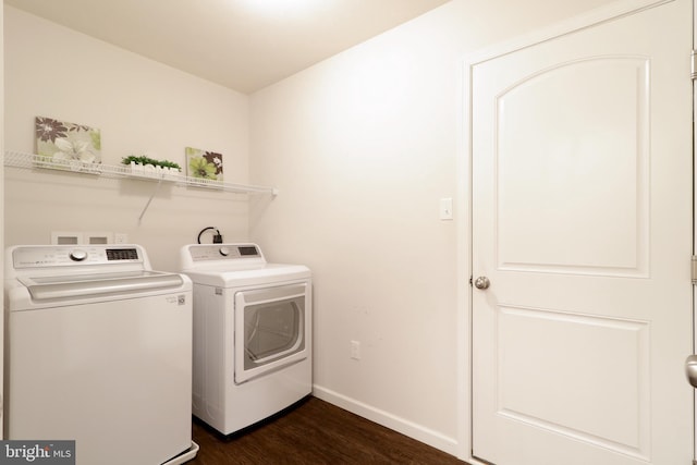 laundry room with washer and clothes dryer and dark wood-type flooring