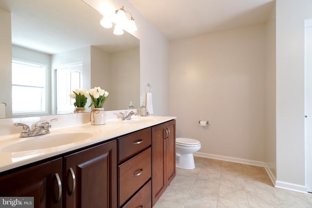 bathroom featuring tile patterned flooring, vanity, and toilet