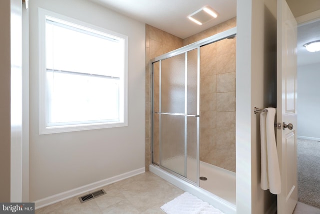 bathroom featuring a shower with shower door