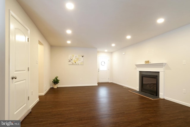 unfurnished living room featuring dark wood-type flooring