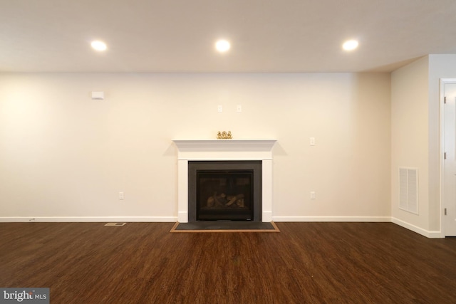 unfurnished living room with dark hardwood / wood-style flooring