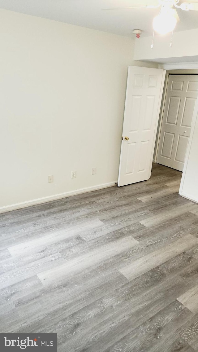 unfurnished room with wood-type flooring