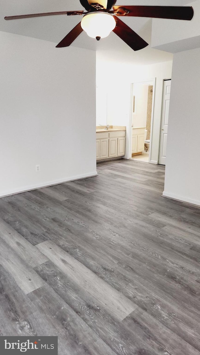 spare room with hardwood / wood-style flooring, sink, and ceiling fan