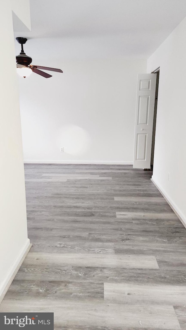 empty room featuring ceiling fan and wood-type flooring