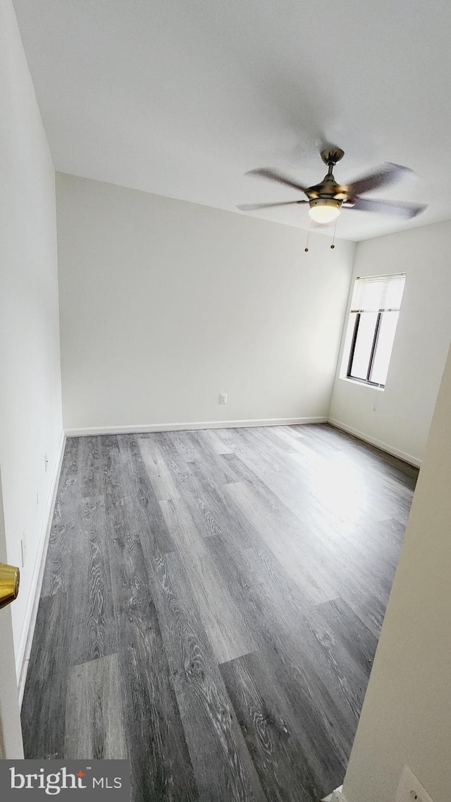 spare room with ceiling fan and dark hardwood / wood-style floors