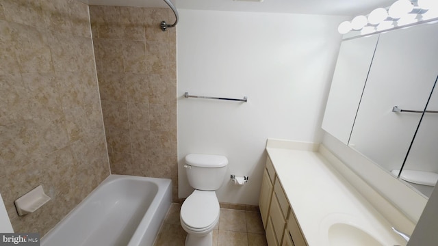 full bathroom featuring tile patterned floors, toilet, vanity, and tiled shower / bath