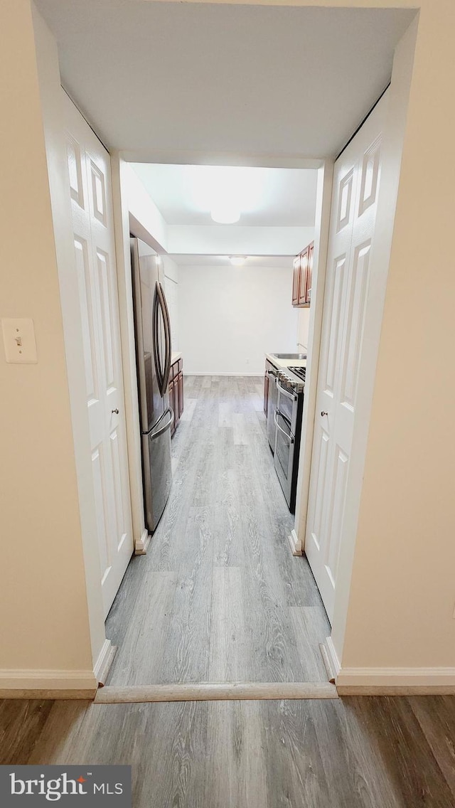 washroom with light wood-type flooring