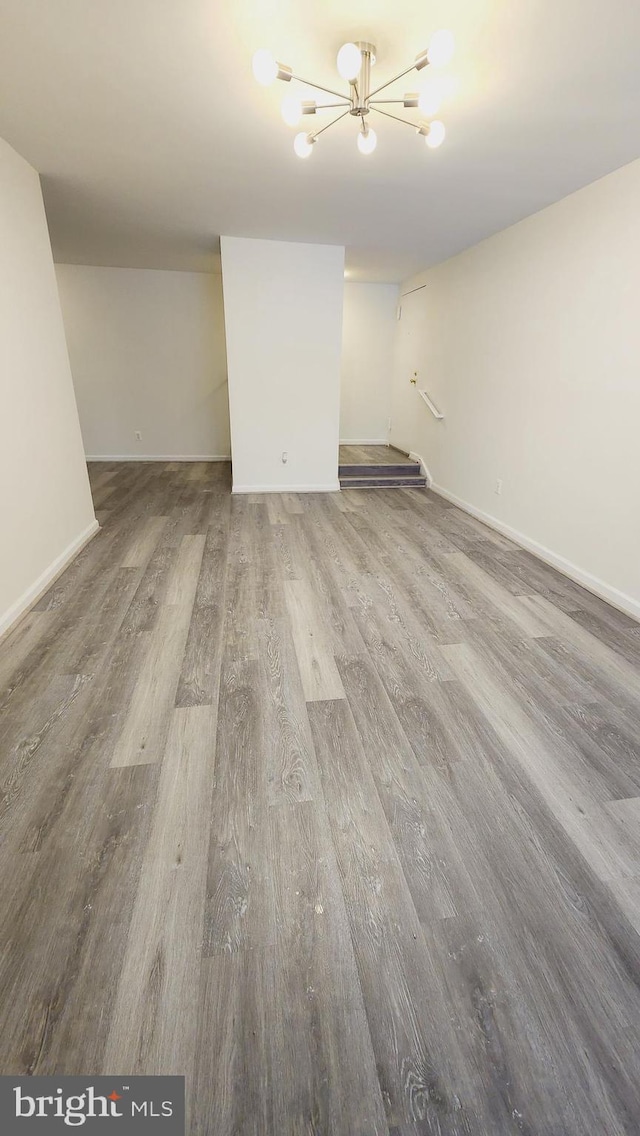 interior space with wood-type flooring and an inviting chandelier