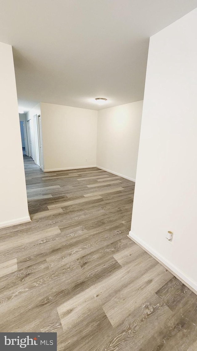 unfurnished room with hardwood / wood-style flooring