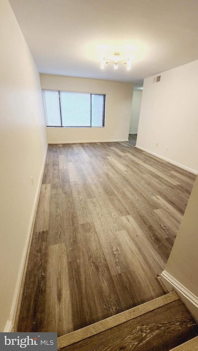 unfurnished room featuring hardwood / wood-style flooring