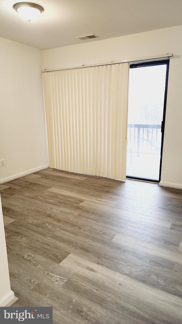 spare room with hardwood / wood-style flooring