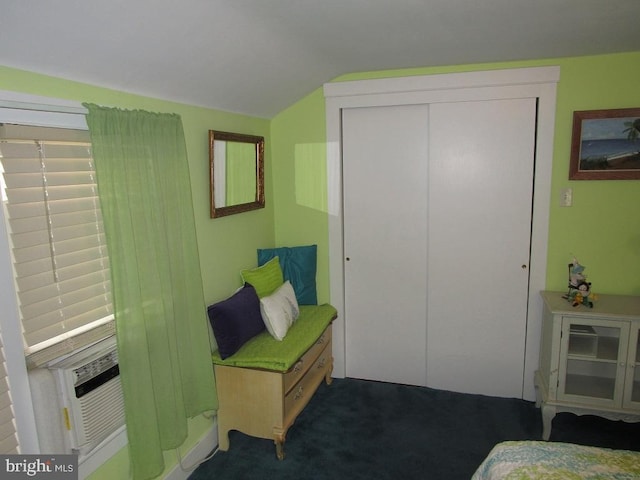 bedroom with lofted ceiling, a closet, cooling unit, and carpet flooring