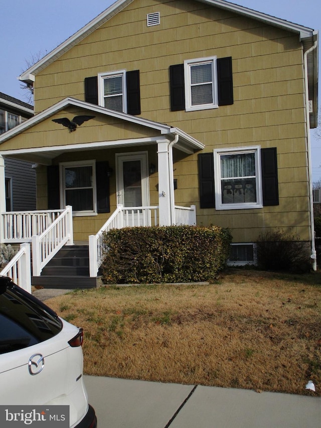 view of front of home with a front lawn and covered porch