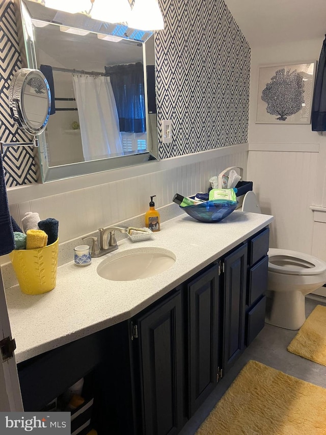 bathroom featuring toilet, a shower with curtain, and vanity