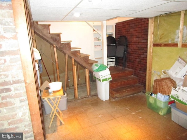 basement featuring a drop ceiling